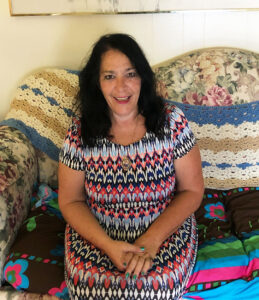 Patricia sitting on her couch